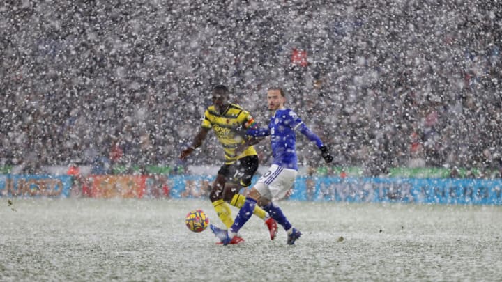 James Maddison of Leicester City holds off Moussa Sissoko of Watford during a snow blizzard on November 28, 2021 in Leicester, England. (Photo by Richard Heathcote/Getty Images)