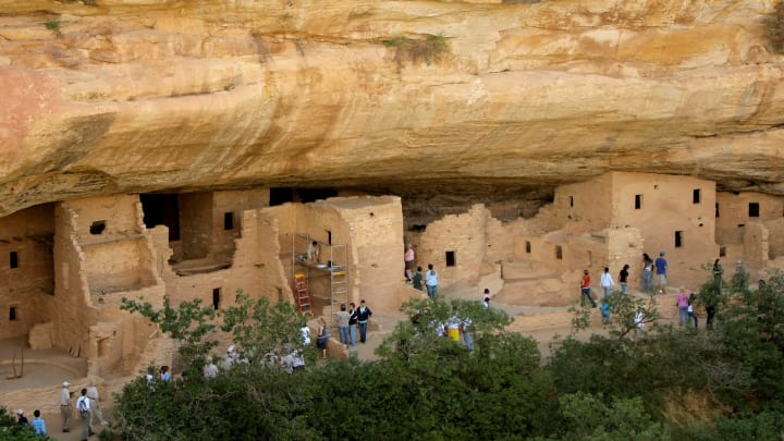 MESA VERDE, CO – AUGUST 07: Spruce Tree House is the best preserved cliff dwelling at Mesa Verde National Park as visitors take a self guided tour on August 7, 2008 in Mesa Verde, Colorado. Mesa Verde, Spanish for green table, offers a spectacular look into the lives of the Ancestral Pueblo people who made it their home for over 700 years, from A.D. 600 to A.D. 1300. Today, the park protects over 4,000 known archeological sites, including 600 cliff dwellings. These sites are some of the most notable and best preserved in the United States. (Photo by Doug Pensinger/Getty Images)