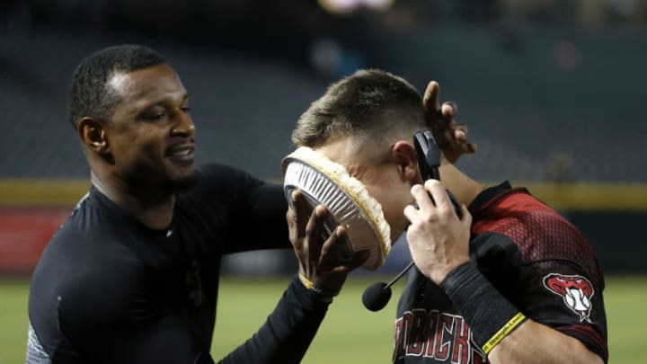 PHOENIX, ARIZONA - SEPTEMBER 16: Jake Lamb #22 of the Arizona Diamondbacks (R) gets a pie in his face from teammate Adam Jones following a 7-5 victory against the Miami Marlins during the MLB game at Chase Field on September 16, 2019 in Phoenix, Arizona. Lamb had a 3-RBI double in the seventh in the Diamondbacks win. (Photo by Ralph Freso/Getty Images)