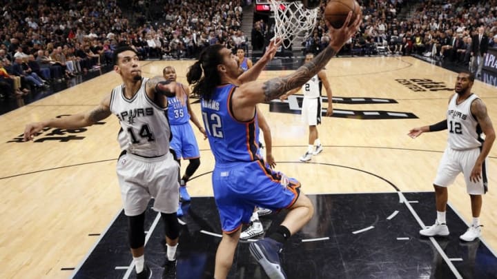 May 2, 2016; San Antonio, TX, USA; Oklahoma City Thunder center Steven Adams (12) dunks the ball past San Antonio Spurs shooting guard Danny Green (14) in game two of the second round of the NBA Playoffs at AT&T Center. Mandatory Credit: Soobum Im-USA TODAY Sports