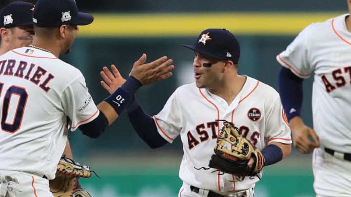 HOUSTON, TX - OCTOBER 05: Jose Altuve #27 of the Houston Astros celebrates a 8-2 win with Yuli Gurriel #10 against the Boston Red Sox during game one of the American League Division Series at Minute Maid Park on October 5, 2017 in Houston, Texas. (Photo by Ronald Martinez/Getty Images)
