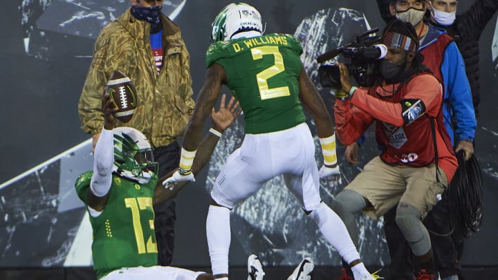 Nov 13, 2021; Eugene, Oregon, USA; Oregon Ducks quarterback Anthony Brown (13) celebrates after scoring a touchdown during the second half with wide receiver Devon Williams (2) against Washington State Cougars at Autzen Stadium. Mandatory Credit: Troy Wayrynen-USA TODAY Sports