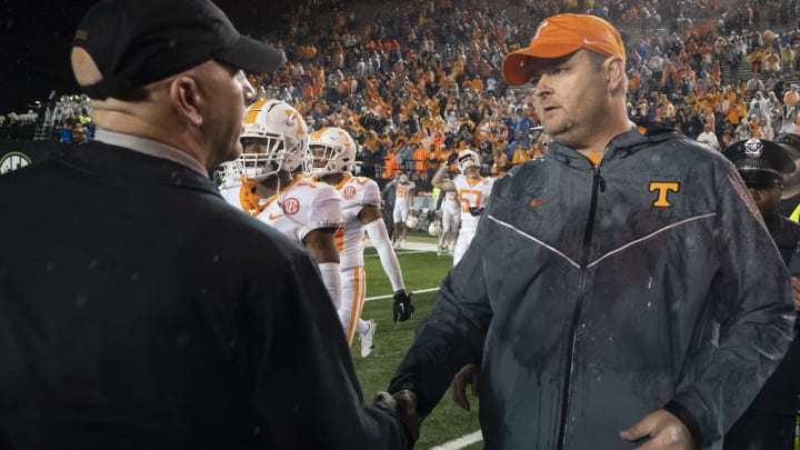 Nov 26, 2022; Nashville, Tennessee, USA; Vanderbilt Commodores head coach Clark Lea and Tennessee Volunteers head coach Josh Heupel meet at midfield after after a game at FirstBank Stadium. Tennessee won 56-0. Mandatory Credit: George Walker IV – USA TODAY Sports
