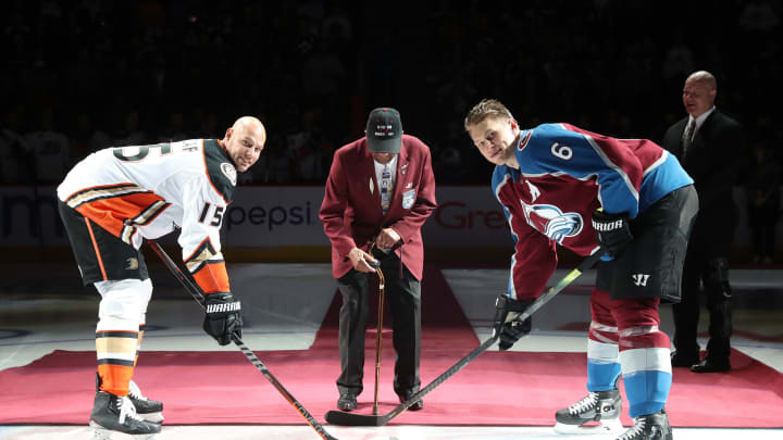 DENVER, CO – MARCH 15: Lieutenant Colonel James Harvey, WWII Tuskegee Airmen and Korean War Veteran drops the ceremonial puck beside Erik Johnson #6 of the Colorado Avalanche and Ryan Getzlaf #15 of the Anaheim Ducks at the Pepsi Center on March 15, 2019 in Denver, Colorado. (Photo by Michael Martin/NHLI via Getty Images)
