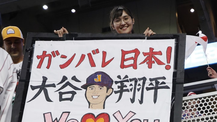 Mar 21, 2023; Miami, Florida, USA; a fan of team Japan holds a sign against USA in the World Baseball Classic at LoanDepot Park. Mandatory Credit: Rhona Wise-USA TODAY Sports