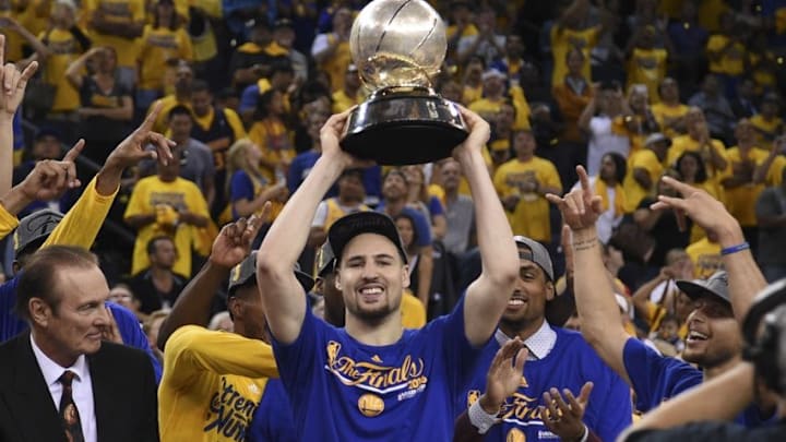 May 30, 2016; Oakland, CA, USA; Golden State Warriors guard Klay Thompson (11) hoists the trophy after game seven of the Western conference finals of the NBA Playoffs against the Oklahoma City Thunder at Oracle Arena. The Warriors defeated the Thunder 96-88. Mandatory Credit: Kyle Terada-USA TODAY Sports