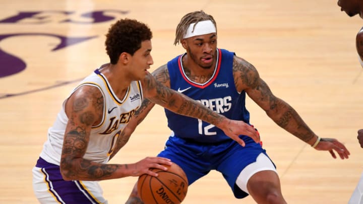 Dec 11, 2020; Los Angeles, California, USA; Los Angeles Clippers guard Ky Bowman (12) guards Los Angeles Lakers forward Kyle Kuzma (0) as he takes the ball down court in the second half of the game at Staples Center. Mandatory Credit: Jayne Kamin-Oncea-USA TODAY Sports
