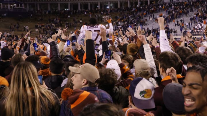 Nov 27, 2021; Charlottesville, Virginia, USA; Virginia Tech Hokies defensive back Armani Chatman (27) celebrates with teammates and fans while holding the Commonwealth Cup after the Hokies' game against the Virginia Cavaliers at Scott Stadium. Mandatory Credit: Geoff Burke-USA TODAY Sports