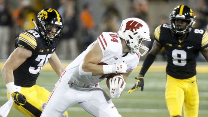 IOWA CITY, IOWA- SEPTEMBER 22: Tight end Jake Ferguson #84 of the Wisconsin Badgers runs up the field in the second half between defensive backs Matt Hankins #8 and Jake Gervase #30 of the Iowa Hawkeyes, on September 22, 2018 at Kinnick Stadium, in Iowa City, Iowa. (Photo by Matthew Holst/Getty Images)