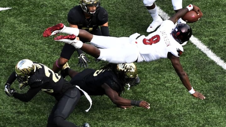 WINSTON SALEM, NC - OCTOBER 28: Quarterback Lamar Jackson #8 of the Louisville Cardinals leaps over Wake Forest Demon Deacon defensemen early in the third quarter of the football game at BB&T Field on October 28, 2017 in Winston Salem, North Carolina. (Photo by Mike Comer/Getty Images)