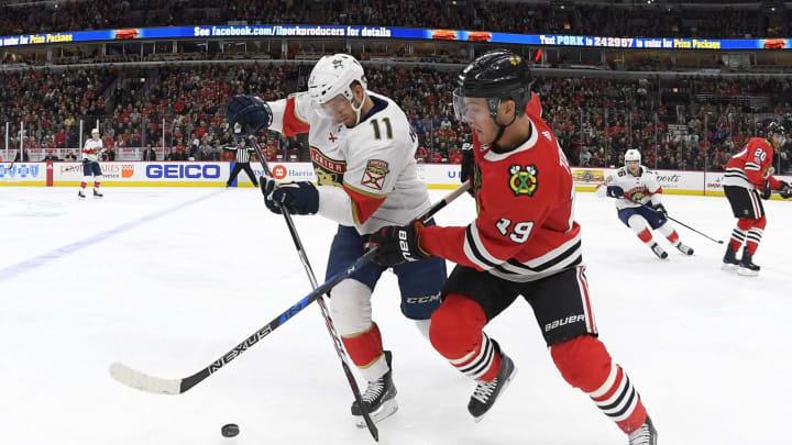 CHICAGO, IL – DECEMBER 12: Chicago Blackhawks center Jonathan Toews (19) battles with Florida Panthers left wing Jonathan Huberdeau (11) for a loose puck in action during the first period of a game between the Chicago Blackhawks and the Florida Panthers on December 12, 2017, at the United Center in Chicago, IL. (Photo by Robin Alam/Icon Sportswire via Getty Images)