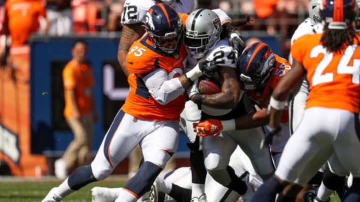 DENVER, CO – SEPTEMBER 16: Running back Marshawn Lynch #24 of the Oakland Raiders is hit by defensive end Derek Wolfe #95 of the Denver Broncos in the first quarter of a game at Broncos Stadium at Mile High on September 16, 2018, in Denver, Colorado. (Photo by Matthew Stockman/Getty Images)