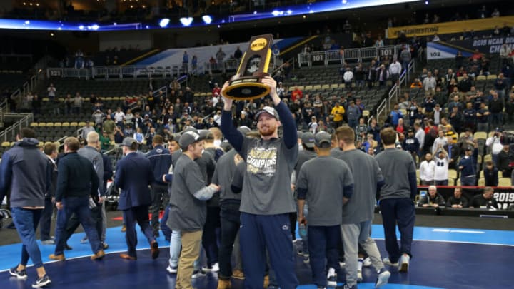 PITTSBURGH, PA - MARCH 23: Bo Nickal of the Penn State Nittany Lions holds the trophy as he celebrates with teammates after winning the team title of the NCAA Wrestling Championships on March 23, 2019 at PPG Paints Arena in Pittsburgh, Pennsylvania. (Photo by Hunter Martin/NCAA Photos via Getty Images)