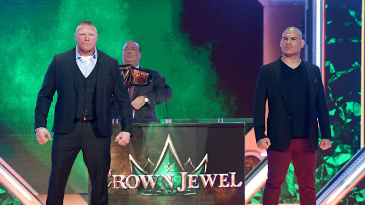 LAS VEGAS, NEVADA - OCTOBER 11: WWE champion Brock Lesnar (L) and former UFC heavyweight champion Cain Velasquez (R) pose as Lesnar's advocate Paul Heyman (C) looks on during the announcement of their match at a WWE news conference at T-Mobile Arena on October 11, 2019 in Las Vegas, Nevada. Lesnar will face Velasquez and WWE wrestler Braun Strowman will take on heavyweight boxer Tyson Fury at the WWE's Crown Jewel event at Fahd International Stadium in Riyadh, Saudi Arabia on October 31. (Photo by Ethan Miller/Getty Images)