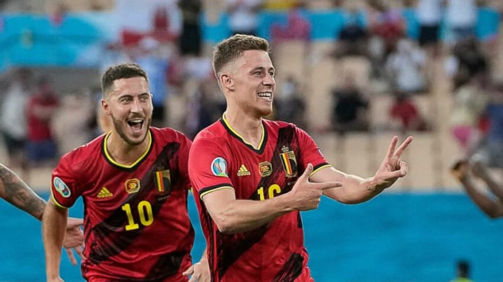 Belgium's midfielder Thorgan Hazard (R) celebrates after scoring the first goal during the UEFA EURO 2020 round of 16 football match between Belgium and Portugal at La Cartuja Stadium in Seville on June 27, 2021. (Photo by THANASSIS STAVRAKIS / POOL / AFP) (Photo by THANASSIS STAVRAKIS/POOL/AFP via Getty Images)