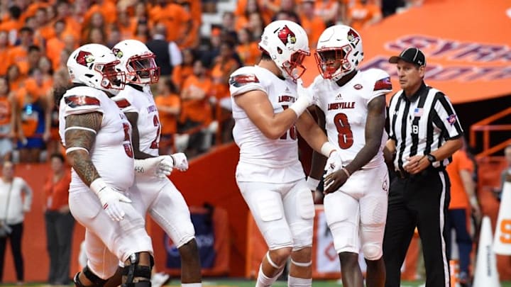 Sep 9, 2016; Syracuse, NY, USA; Louisville Cardinals quarterback Lamar Jackson (8) celebrates his touchdown run with teammates against the Syracuse Orange during the first quarter at the Carrier Dome. Mandatory Credit: Rich Barnes-USA TODAY Sports