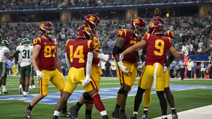 Jan 2, 2023; Arlington, Texas, USA; USC Trojans wide receiver Michael Jackson III (9) and offensive lineman Courtland Ford (74) and running back Raleek Brown (14) and tight end Lake McRee (87) celebrate after Jackson scores a touchdown against the Tulane Green Wave during the first half in the 2023 Cotton Bowl at AT&T Stadium. Mandatory Credit: Jerome Miron-USA TODAY Sports
