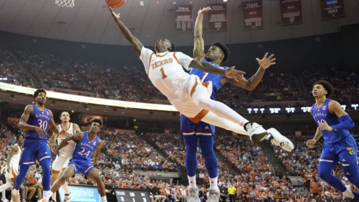 Feb 7, 2022; Austin, Texas, USA; Texas Longhorns guard Andrew Jones (1) drives to the basket while defended by Kansas Jayhawks guard Joseph Yesufu (1) during the first half at Frank C. Erwin Jr. Center. Mandatory Credit: Scott Wachter-USA TODAY Sports