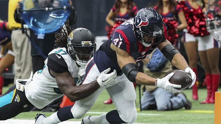 Jan 3, 2016; Houston, TX, USA; Houston Texans running back Jonathan Grimes (41) scores a touchdown as Jacksonville Jaguars strong safety Johnathan Cyprien (37) defends during the second quarter at NRG Stadium. Mandatory Credit: Troy Taormina-USA TODAY Sports