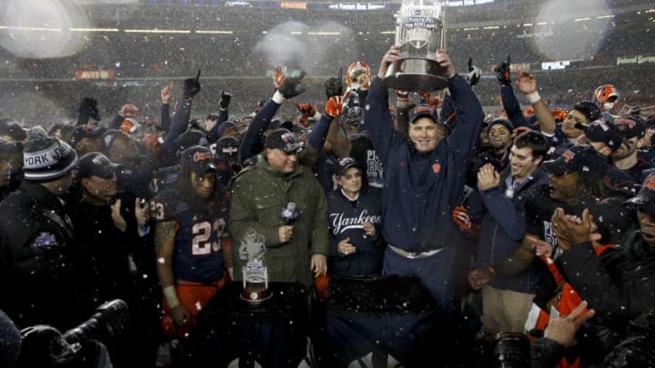 NEW YORK, NY - DECEMBER 29: Head coach Doug Marrone of the Syracuse Orange hoists the trophy after victory over the West Virginia Mountaineers in the New Era Pinstripe Bowl at Yankee Stadium on December 29, 2012 in the Bronx borough of New York City. (Photo by Jeff Zelevansky/Getty Images)