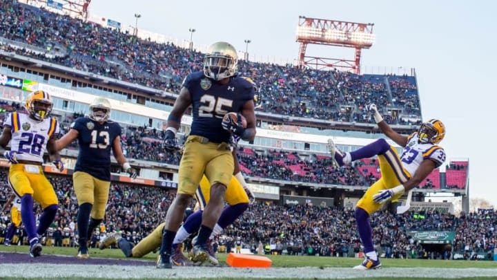 Dec 30, 2014; Nashville, TN, USA; Notre Dame Fighting Irish running back Tarean Folston (25) scores a touchdown in front of Louisiana State Tigers safety Jamal Adams (33) in the second quarter at LP Field. Mandatory Credit: Matt Cashore-USA TODAY Sports