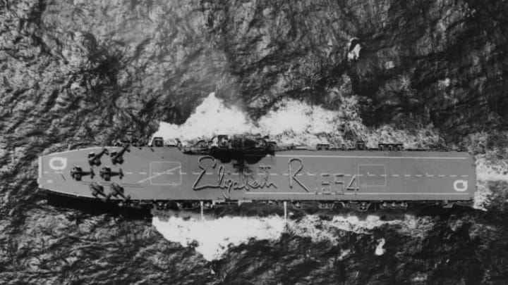 The HMAS Vengeance seen from a helicopter, as the Australian Naval crew spell out the signature of Queen Elizabeth II on the deck, in 1954.