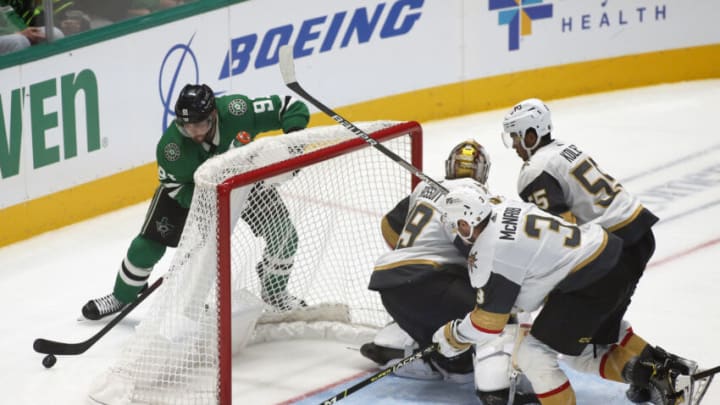 Oct 27, 2021; Dallas, Texas, USA; Dallas Stars center Tyler Seguin (91) works around the back of the net against Vegas Golden Knights goaltender Laurent Brossoit (39) and defenseman Brayden McNabb (3) and right wing Keegan Kolesar (55) during the third period at American Airlines Center. Mandatory Credit: Raymond Carlin III-USA TODAY Sports