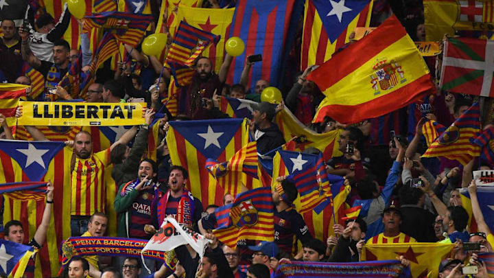 BARCELONA, SPAIN - APRIL 21: A FC Barcelona supporter waves a Spanish flag among Catalonia's Pro-Independence flags prior to the Spanish Copa del Rey Final match between Barcelona and Sevilla at Wanda Metropolitano stadium on April 21, 2018 in Barcelona, Spain. (Photo by David Ramos/Getty Images)