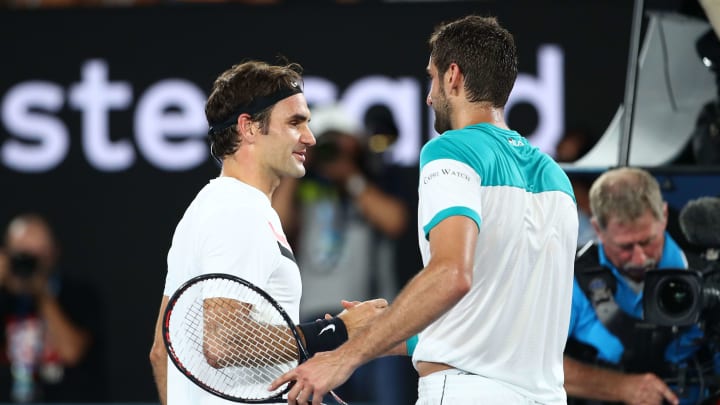 MELBOURNE, AUSTRALIA – JANUARY 28: Roger Federer of Switzerland is congratulated by Marin Cilic of Croatia after Federer won the men’s singles final match on day 14 of the 2018 Australian Open at Melbourne Park on January 28, 2018 in Melbourne, Australia. (Photo by Clive Brunskill/Getty Images)