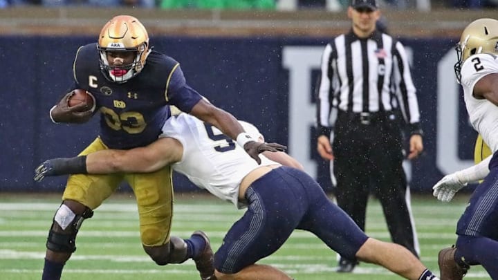 SOUTH BEND, IN - NOVEMBER 18: Josh Adams #33 of the Notre Dame Fighting Irish gets around Winn Howard #51 of the Navy Midshipmen at Notre Dame Stadium on November 18, 2017 in South Bend, Indiana. (Photo by Jonathan Daniel/Getty Images)