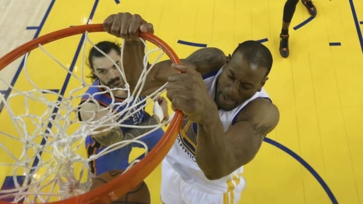 May 30, 2016; Oakland, CA, USA; Golden State Warriors forward Andre Iguodala (9) dunks on Oklahoma City Thunder center Steven Adams (12) in the first half of game seven of the Western conference finals of the NBA Playoffs at Oracle Arena. The Warriors defeated the Thunder 96-88. Mandatory Credit: Ezra Shaw-Pool Photo via USA TODAY Sports