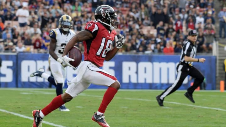 Dec 11, 2016; Los Angeles, CA, USA; Atlanta Falcons wide receiver Taylor Gabriel (18) scores on a 64-yard touchdown reception in the third quarter against the Los Angeles Rams at Los Angeles Memorial Coliseum. Mandatory Credit: Kirby Lee-USA TODAY Sports