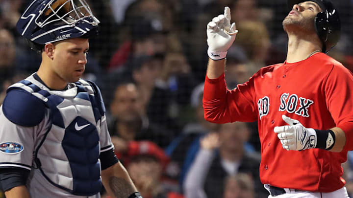 BOSTON, MA - OCTOBER 5: Red Sox designated hitter J.D. Martinez (right) and Yankees catcher Gary Sanchez (left) have very different reactions as Martinez crosses the plate following his bottom of the first inning three run home run. The Boston Red Sox hosted the New York Yankees in Game 1 of the ALDS at Fenway Park in Boston on Oct. 05, 2018. (Photo by Jim Davis/The Boston Globe via Getty Images)