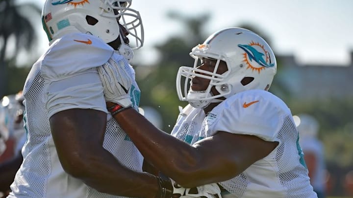 Aug 10, 2016; Miami Gardens, FL, USA; Miami Dolphins offensive tackle Branden Albert (76) runs defensive drills against offensive tackle Laremy Tunsil (67) during practice at Baptist Health Training Facility. Mandatory Credit: Jasen Vinlove-USA TODAY Sports