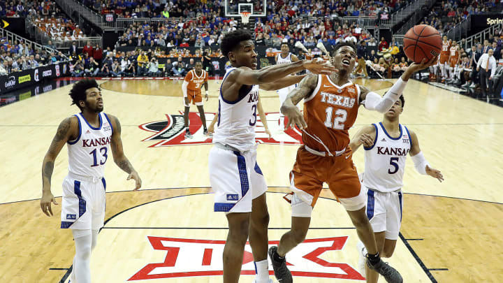 KANSAS CITY, MISSOURI – MARCH 14: Kerwin Roach II #12 of the Texas Longhorns drives to the basket as Ochai Agbaji #30 of the Kansas Jayhawks defends during the quarterfinal game of the Big 12 Basketball Tournament at Sprint Center on March 14, 2019 in Kansas City, Missouri. (Photo by Jamie Squire/Getty Images)