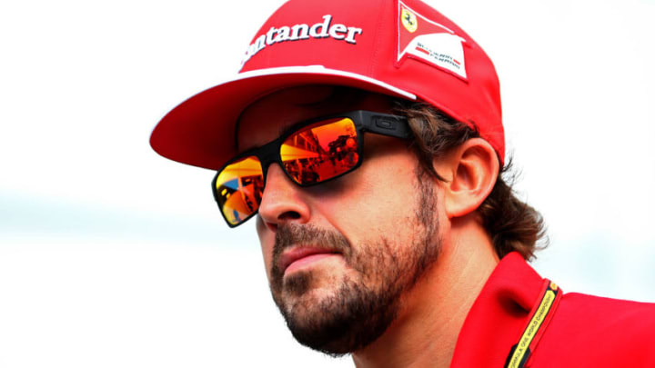SINGAPORE - SEPTEMBER 18: Fernando Alonso of Spain and Ferrari walks through the paddock during previews ahead of the Singapore Formula One Grand Prix at Marina Bay Street Circuit on September 18, 2014 in Singapore, Singapore. (Photo by Mark Thompson/Getty Images)