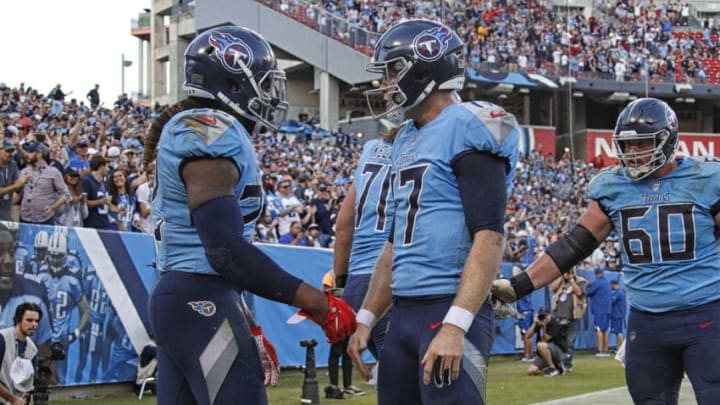 NASHVILLE, TENNESSEE - OCTOBER 20: Derrick Henry #22 of the Tennessee Titans is congratulated by teammate Ryan Tannehill #17 after scoring a touchdown against the Los Angeles Chargers during the second half at Nissan Stadium on October 20, 2019 in Nashville, Tennessee. (Photo by Frederick Breedon/Getty Images)