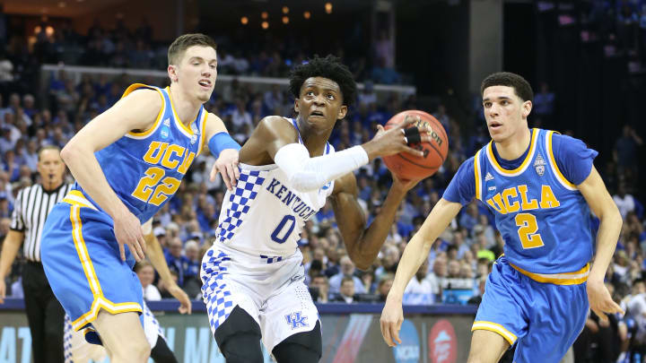 Mar 24, 2017; Memphis, TN, USA;Kentucky Wildcats guard De’Aaron Fox (0) drives between UCLA Bruins forward TJ Leaf (22) and guard Lonzo Ball (2) in the first half during the semifinals of the South Regional of the 2017 NCAA Tournament at FedExForum. Mandatory Credit: Nelson Chenault-USA TODAY Sports