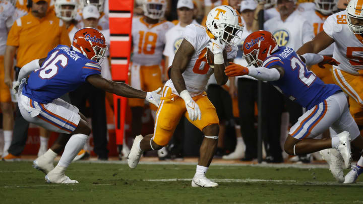 Sep 25, 2021; Gainesville, Florida, USA; Tennessee Volunteers running back Tiyon Evans (8) runs the ball past Florida Gators safety Tre’Vez Johnson (16) and Florida Gators safety Rashad Torrence II (22) for a touchdown against the Florida Gators during the first quarter at Ben Hill Griffin Stadium. Mandatory Credit: Kim Klement-USA TODAY Sports