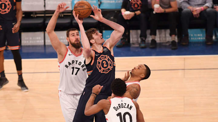 NEW YORK, NY - MARCH 11: Luke Kornet #2 of the New York Knicks lays up a shot against CJ Miles #0 of the Toronto Raptors during the game at Madison Square Garden on March 11, 2018 in New York City, New York. NOTE TO USER: User expressly acknowledges and agrees that, by downloading and or using this photograph, User is consenting to the terms and conditions of the Getty Images License Agreement. (Photo by Matteo Marchi/Getty Images)