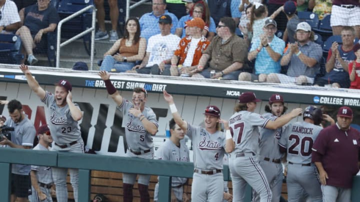 Jun 20, 2021; Omaha, Nebraska, USA; Mississippi State Bulldogs celebrate after first baseman Luke Hancock (20) (not pictured) scored a run against the Texas Longhorns at TD Ameritrade Park. Mandatory Credit: Bruce Thorson-USA TODAY Sports