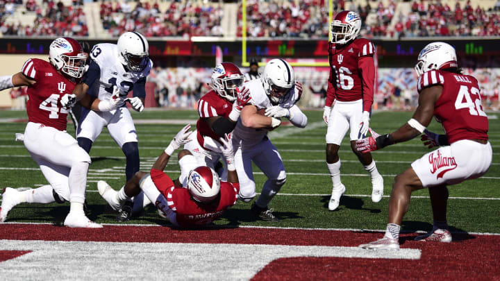 Nov 12, 2016; Bloomington, IN, USA; Penn State Nittany Lions quarterback Trace McSorley (9) runs over Indiana Hoosiers defenders to score a touchdown during the first quarter of the game at Memorial Stadium. Mandatory Credit: Marc Lebryk-USA TODAY Sports