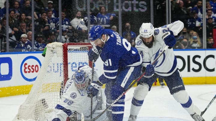 May 4, 2022; Toronto, Ontario, CAN; Toronto Maple Leafs forward John Tavares (91) and Tampa Bay Lightning goaltender Andrei Vasilevskiy (88) and defenseman Zach Bogosian (24) battle for the puck during the third period of game two of the first round of the 2022 Stanley Cup Playoffs at Scotiabank Arena. Mandatory Credit: John E. Sokolowski-USA TODAY Sports