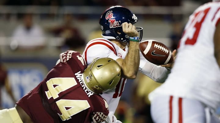 Sep 5, 2016; Orlando, FL, USA; Mississippi Rebels quarterback Chad Kelly (10) fumbles the ball after being hit by Florida State Seminoles defensive end DeMarcus Walker (44) in the third quarter at Camping World Stadium. Mandatory Credit: Logan Bowles-USA TODAY Sports