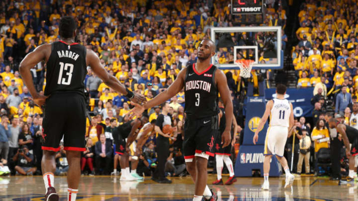 OAKLAND, CA - MAY 8: James Harden #13 and Chris Paul #3 of the Houston Rockets high five during Game Five of the Western Conference Semifinals of the 2019 NBA Playoffs against the Golden State Warriors on May 8, 2019 at ORACLE Arena in Oakland, California. NOTE TO USER: User expressly acknowledges and agrees that, by downloading and/or using this photograph, user is consenting to the terms and conditions of Getty Images License Agreement. Mandatory Copyright Notice: Copyright 2019 NBAE (Photo by Joe Murphy/NBAE via Getty Images)