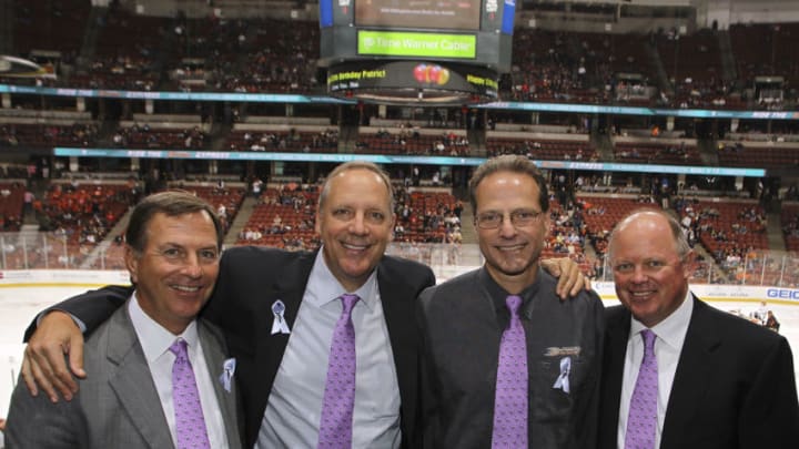 ANAHEIM, CA - OCTOBER 21: (L-R) Anaheim Ducks CEO Michael Schulman, Executive Vice President and COO Tim Ryan, owner Henry Samueli, Executive Vice President and General Manager Bob Murray pose for a photo wearing purple ties in honor of Hockey FIghts Cancer night during the game against the Dallas Stars on October 21, 2011 at Honda Center in Anaheim, California. (Photo by Debora Robinson/NHLI via Getty Images)