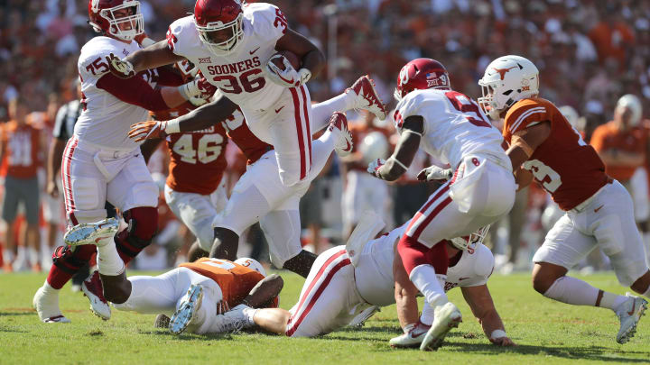 DALLAS, TX – OCTOBER 14: Dimitri Flowers #36 of the Oklahoma Sooners leaps over a Texas Longhorns defender for a first down in the second quarter at Cotton Bowl on October 14, 2017 in Dallas, Texas. (Photo by Richard W. Rodriguez/Getty Images)