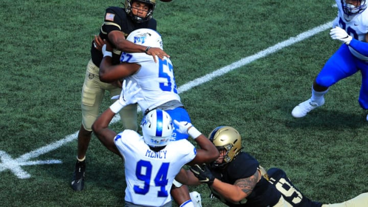 WEST POINT, NEW YORK - SEPTEMBER 05: Christian Anderson #4 of the Army Black Knights passes against Marley Cook #57 of the Middle Tennessee Blue Raiders in the first half at Michie Stadium on September 5, 2020 in West Point, New York. (Photo by Mike Lawrie/Getty Images)