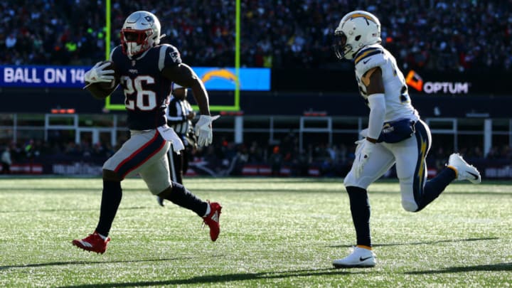 FOXBOROUGH, MASSACHUSETTS - JANUARY 13: Sony Michel #26 of the New England Patriots carries the ball during the first quarter in the AFC Divisional Playoff Game against the Los Angeles Chargers at Gillette Stadium on January 13, 2019 in Foxborough, Massachusetts. (Photo by Adam Glanzman/Getty Images)