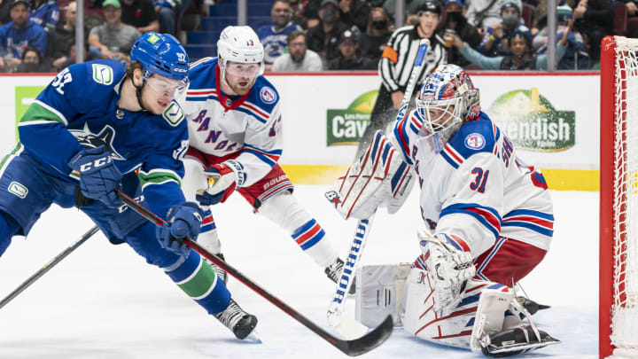 VANCOUVER, BC – NOVEMBER 2: Vasily Podkolzin #92 of the Vancouver Canucks tries to put a backhand shot on goalie Igor Shesterkin #31 of the New York Rangers after getting past Alexis Lafreniere #13 during the second period on November, 2, 2021 at Rogers Arena in Vancouver, British Columbia, Canada. (Photo by Rich Lam/Getty Images)